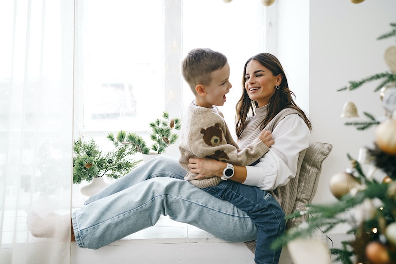 happy mother with son sit on windowsill near chris 2022 01 11 17 49 42 utc