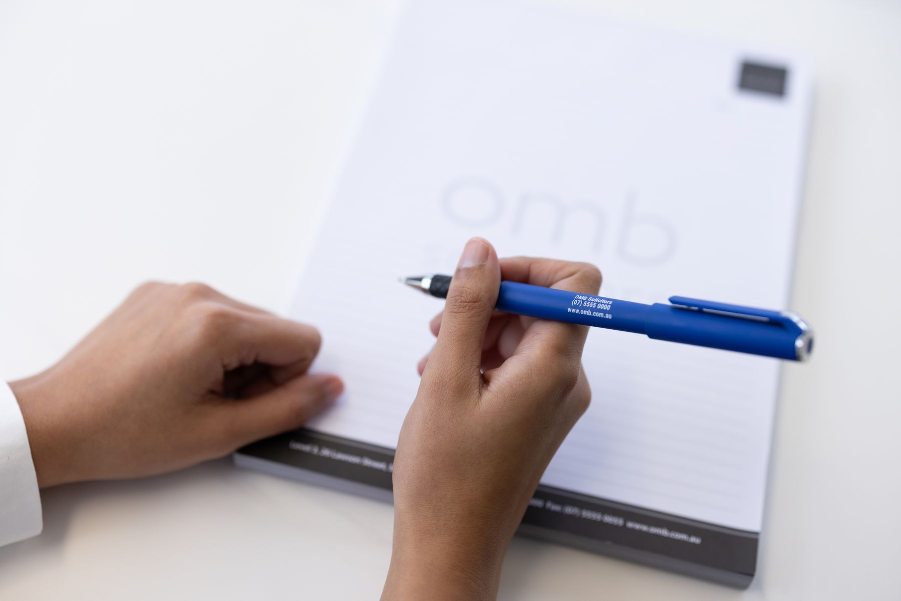 A client signing a property contract with an OMB pen